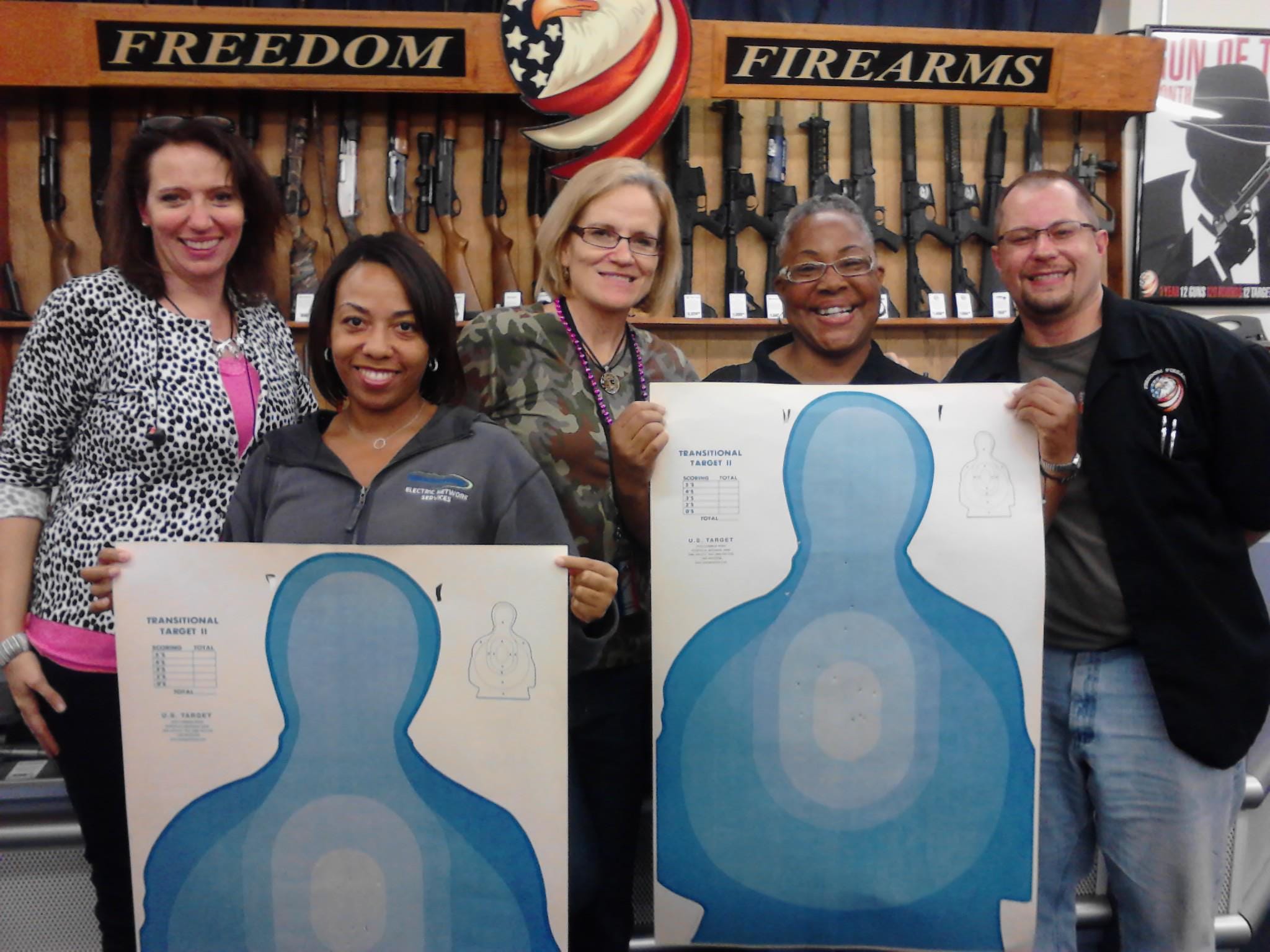 Students at Freedom Firearms in Battle Creek holding their targets at the end of a CPL class